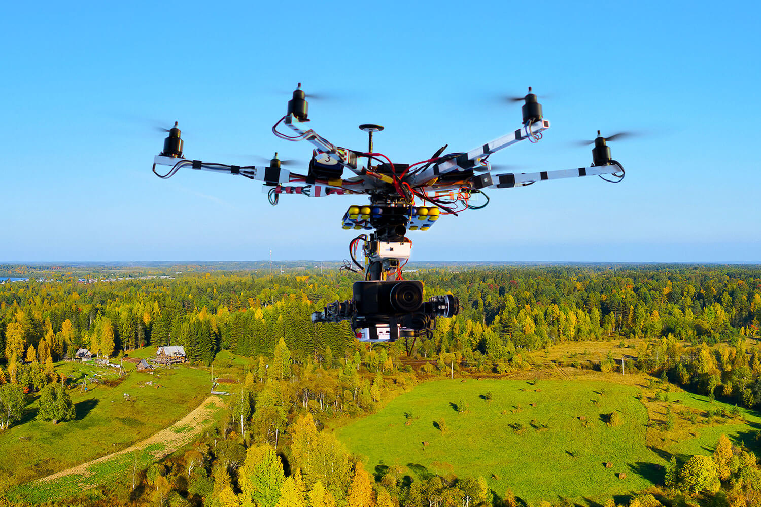 Unmanned Aerial Vehicles (UAV) Flying over the forest and fields with GPS tracking